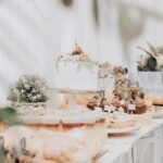 Beautifully arranged dessert table with cakes and cupcakes at a wedding reception.